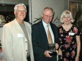 Dave Schave and Mary Ellen Gabel presenting Ole to Jerry Swanberg (center)